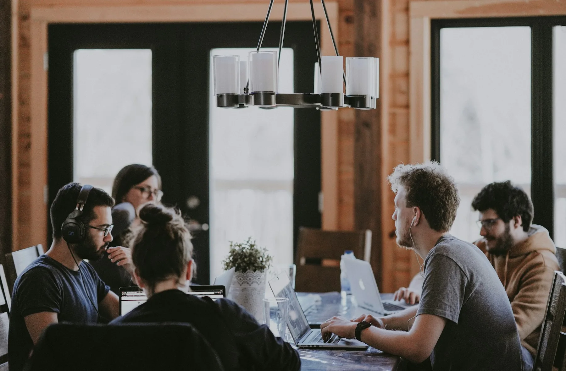 Colleagues collaborating at a shared workplace table.