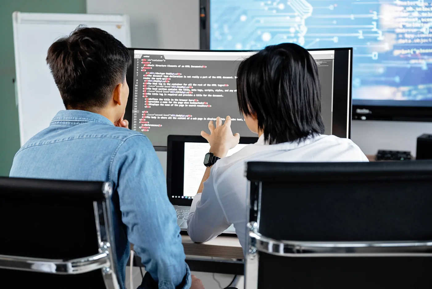 Developers examining application code on a shared screen