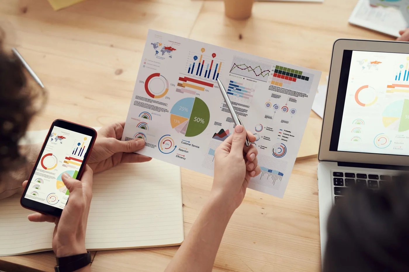 Professionals comparing printed business documents at a table