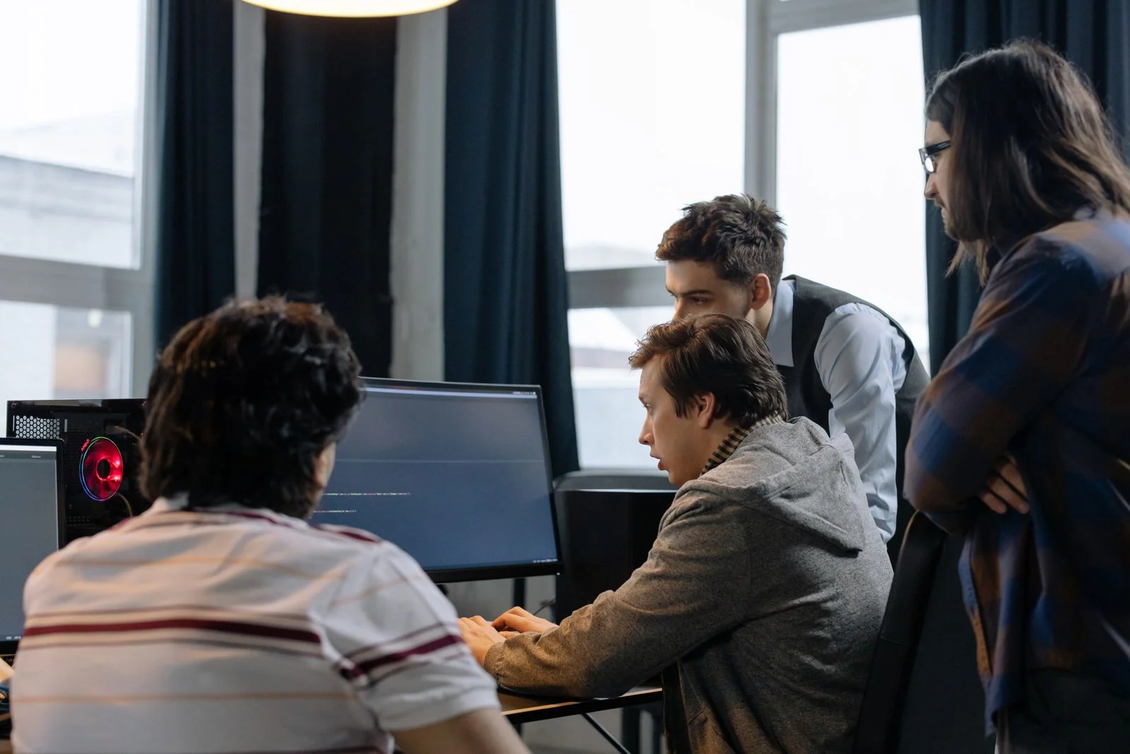 Software engineers reviewing an application together at a workstation